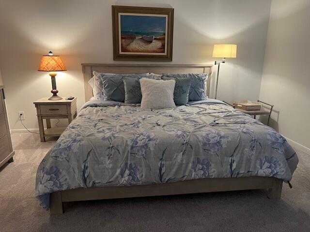 1605 Highway 1, Unit F305 Jupiter, FL 33477 - Photo 22 of 31 a bedroom with a bed and lamp