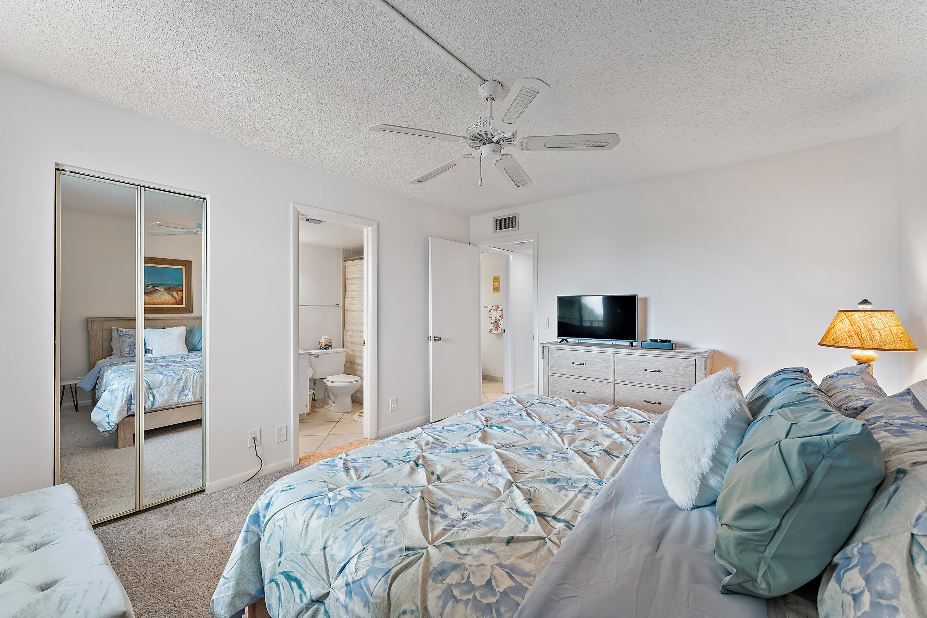 1605 Highway 1, Unit F305 Jupiter, FL 33477 - Photo 24 of 31 a bedroom with a bed and a television