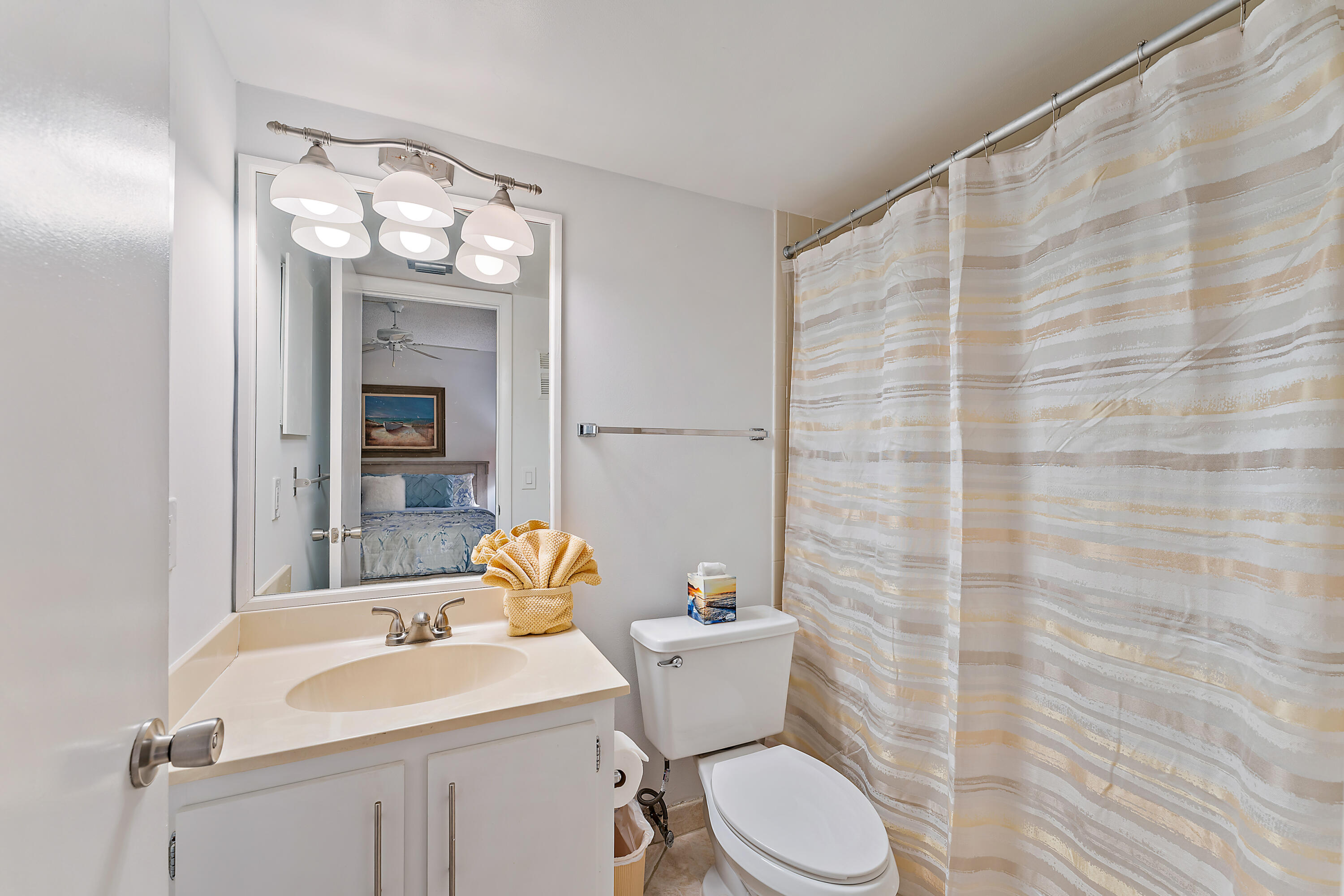 1605 Highway 1, Unit F305 Jupiter, FL 33477 - Photo 25 of 31 a bathroom with a sink a toilet and shower curtain