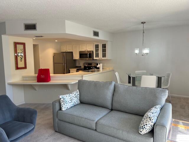 1605 Highway 1, Unit F305 Jupiter, FL 33477 - Photo 9 of 31 a living room with furniture and kitchen view