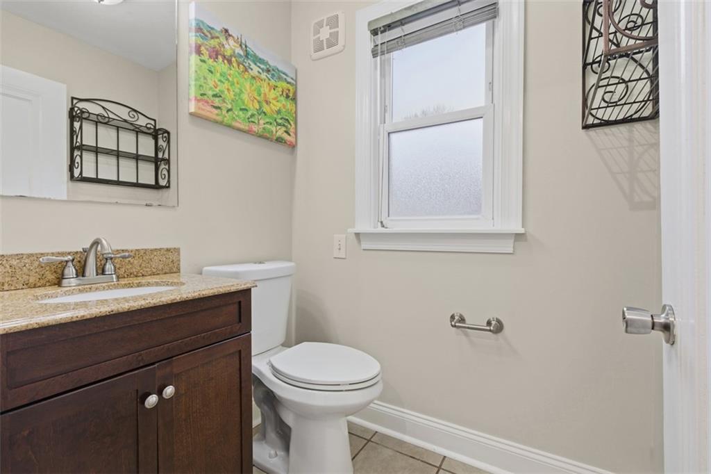312 Friday Road Pittsburgh, PA 15209 - Photo 15 of 43 a bathroom with a toilet a sink and mirror
