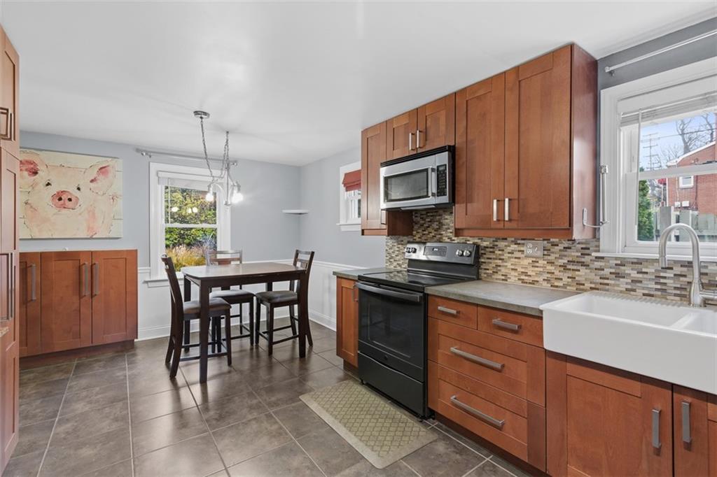 312 Friday Road Pittsburgh, PA 15209 - Photo 19 of 43 a kitchen with granite countertop a sink stove and cabinets
