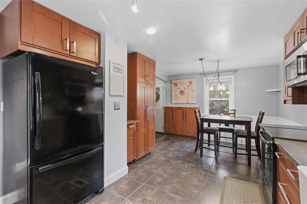 312 Friday Road Pittsburgh, PA 15209 - Photo 20 of 43 a kitchen with refrigerator cabinets and dining table