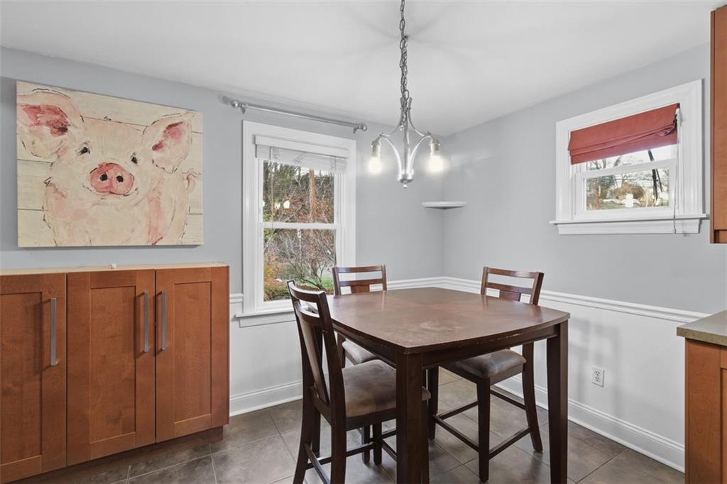 312 Friday Road Pittsburgh, PA 15209 - Photo 21 of 43 a view of a dining room with furniture wooden floor and a chandelier