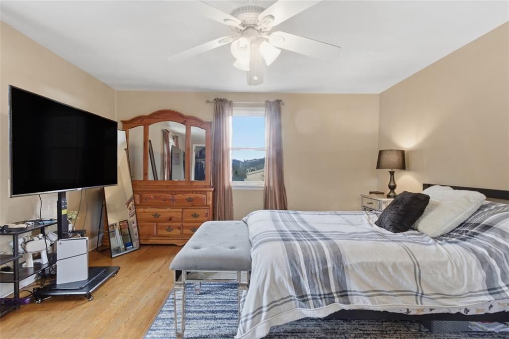 312 Friday Road Pittsburgh, PA 15209 - Photo 27 of 43 a bedroom with a bed and a flat tv screen on dresser