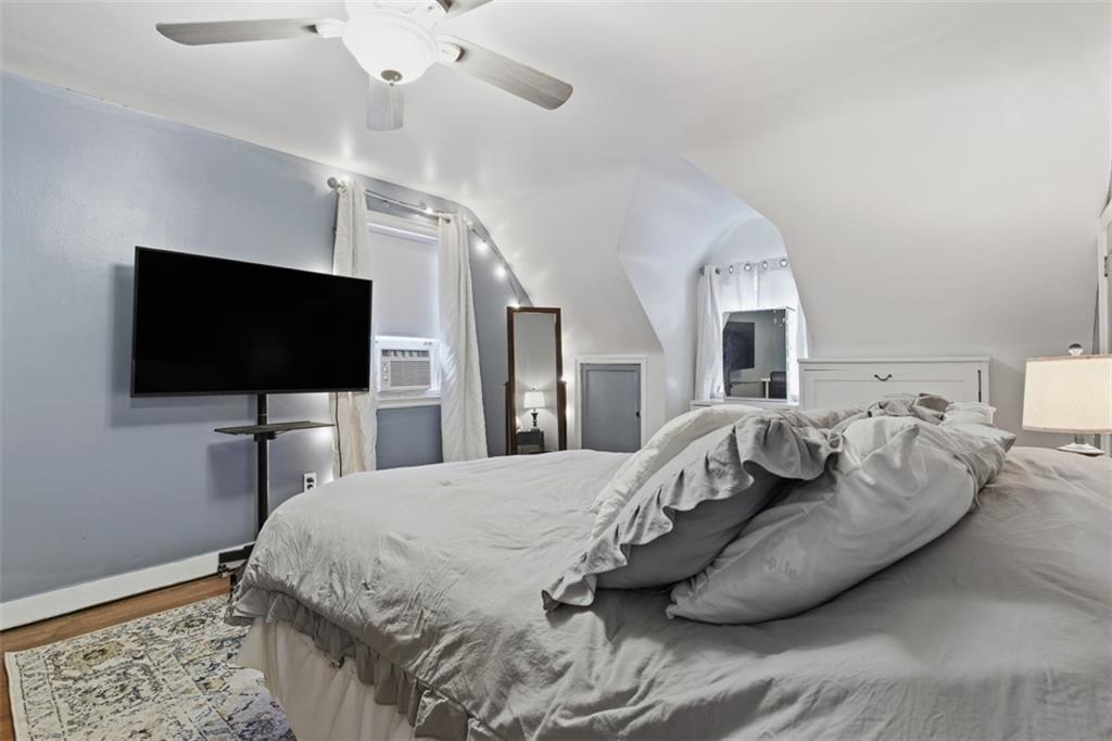 312 Friday Road Pittsburgh, PA 15209 - Photo 29 of 43 a spacious bedroom with a bed and a flat screen tv