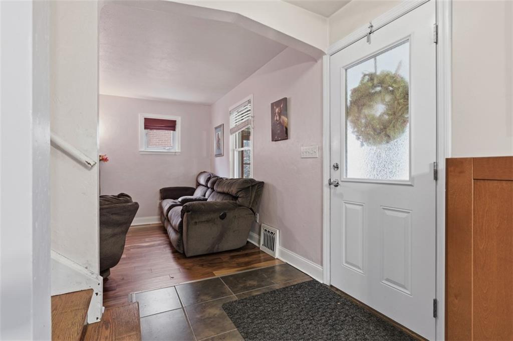 312 Friday Road Pittsburgh, PA 15209 - Photo 8 of 43 a hallway with a couch and cabinets