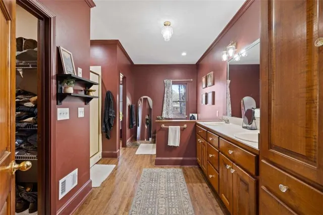 a spacious bathroom with a granite countertop sink and a large mirror