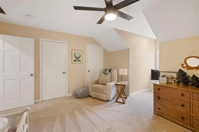 a bedroom with a bed and painting on the wall