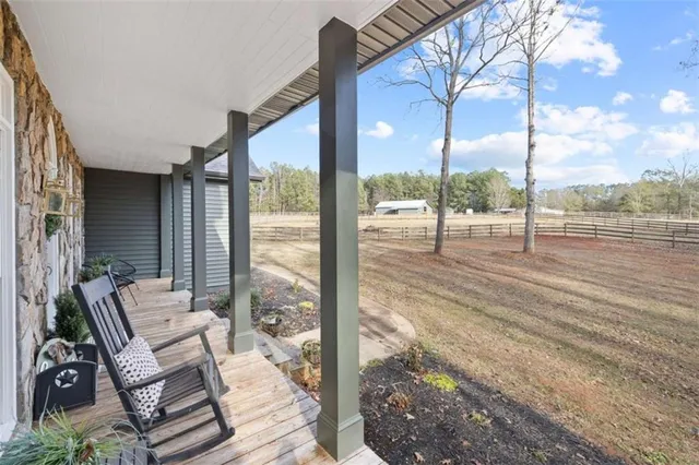 a kitchen with a center island wooden floor and a view of living room