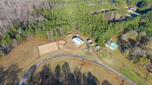 an aerial view of a house with a yard and lake view