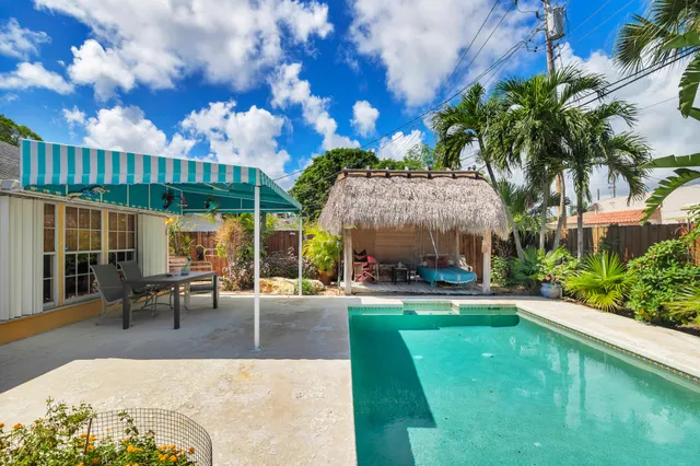 a swimming pool with outdoor seating and yard