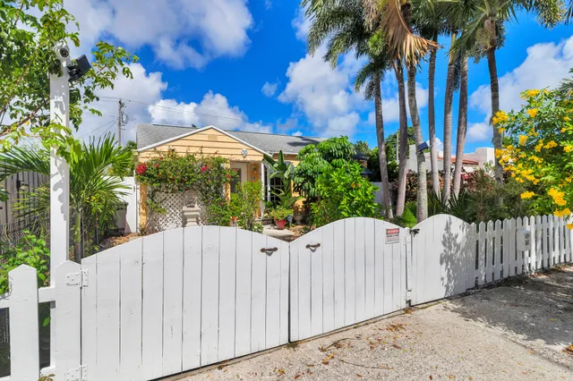 a white house with a yard and entertaining space