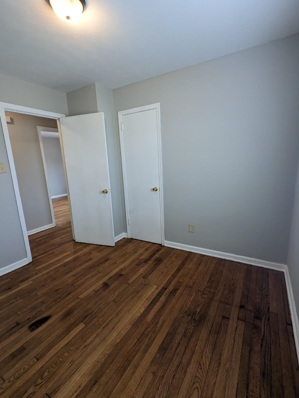 3063 Christine Road Memphis, TN 38118 - Photo 12 of 20 Unfurnished bedroom featuring baseboards and dark wood finished floors