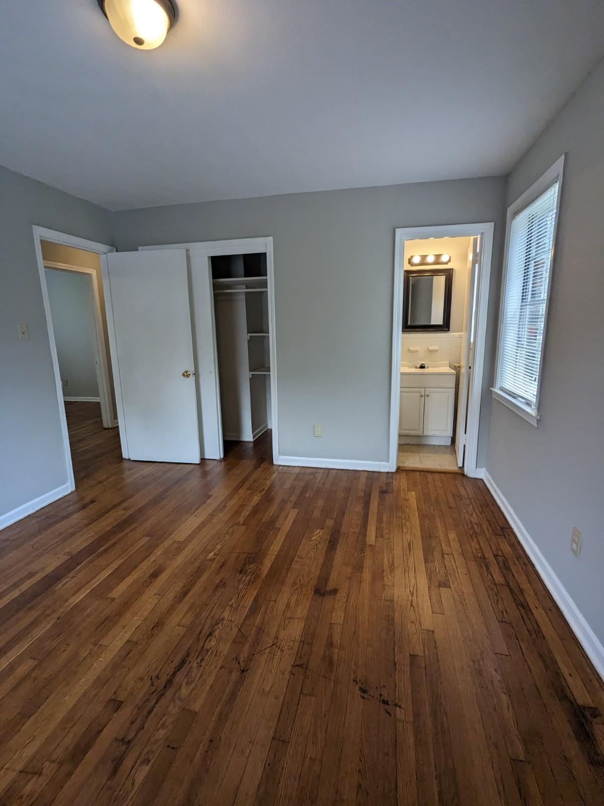 3063 Christine Road Memphis, TN 38118 - Photo 14 of 20 Unfurnished bedroom featuring ensuite bath, dark wood-type flooring, baseboards, and a closet