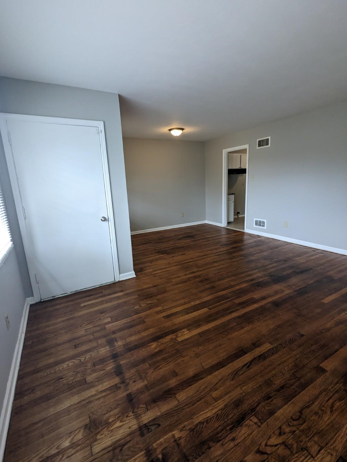 3063 Christine Road Memphis, TN 38118 - Photo 3 of 20 Empty room featuring baseboards, visible vents, and dark wood-style flooring