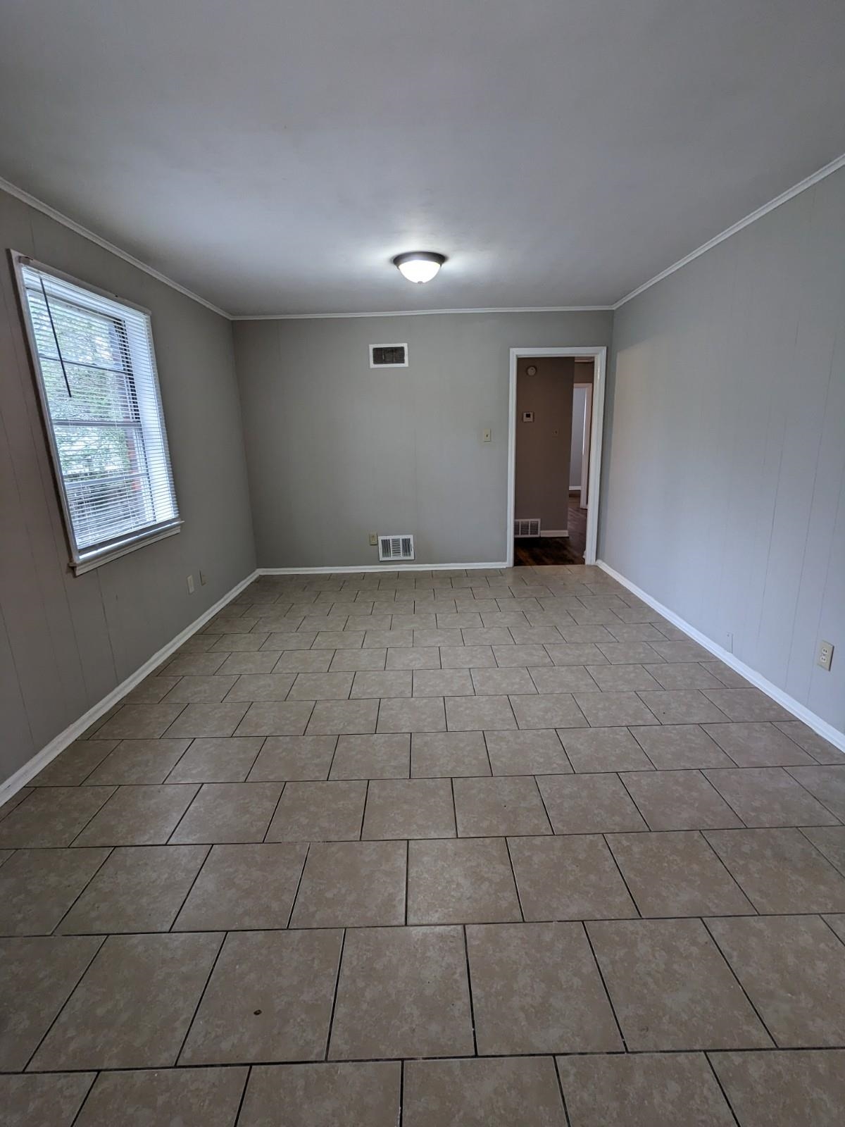 3063 Christine Road Memphis, TN 38118 - Photo 5 of 20 Tiled spare room with visible vents and crown molding