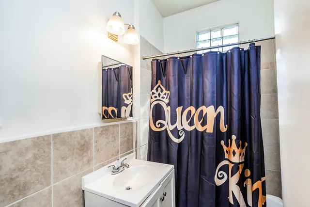 a bathroom with a sink a mirror and a shower