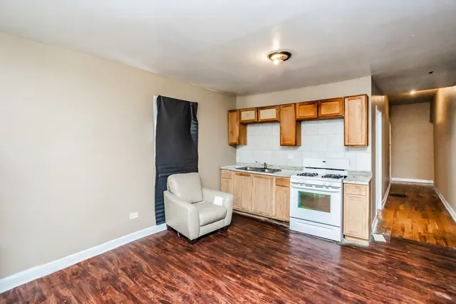 a kitchen with granite countertop white cabinets and white appliances
