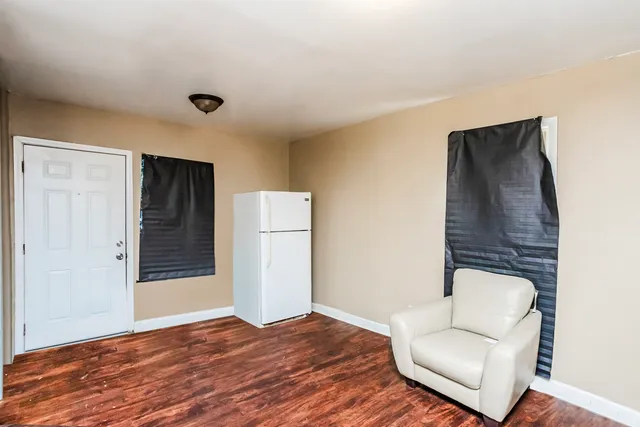a view of a livingroom with wooden floor and a couch