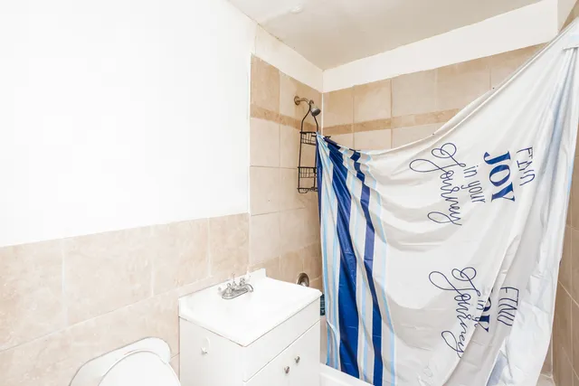 a bathroom with a sink and mirror with bathtub