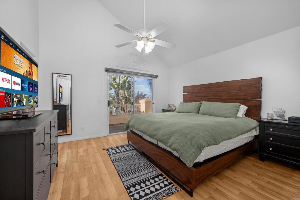 1453 Genoa Drive Vista, CA 92081 - Photo 13 of 32 a bedroom with a large bed and a flat tv screen on dresser