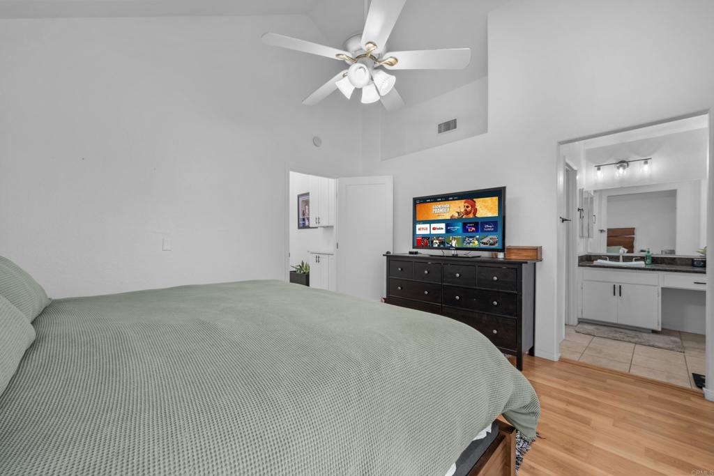 1453 Genoa Drive Vista, CA 92081 - Photo 14 of 32 a bedroom with a bed and a flat screen tv