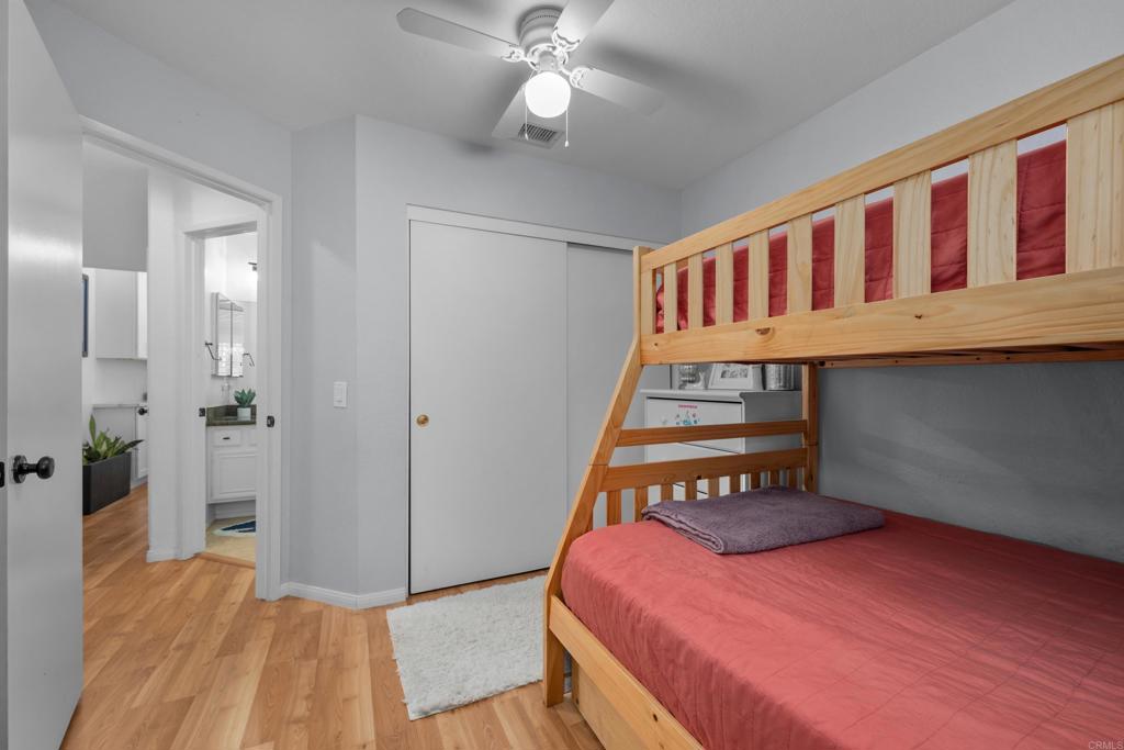 1453 Genoa Drive Vista, CA 92081 - Photo 21 of 32 a bedroom with furniture and a chandelier