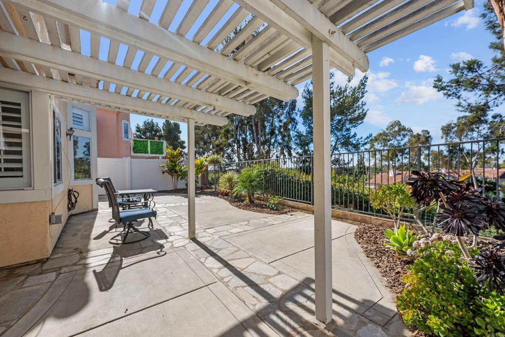 1453 Genoa Drive Vista, CA 92081 - Photo 24 of 32 a view of a patio with table and chairs and potted plants