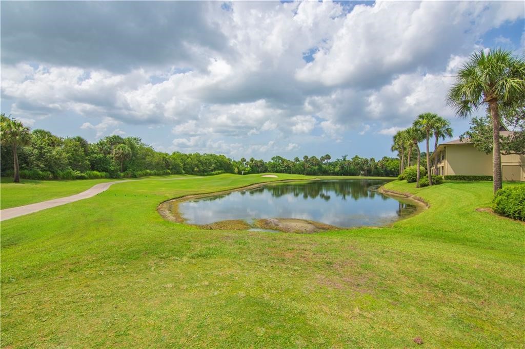 27 Plantation Drive, Unit 202 Vero Beach, FL 32966 - Photo 25 of 30 a view of a lake with houses in the back
