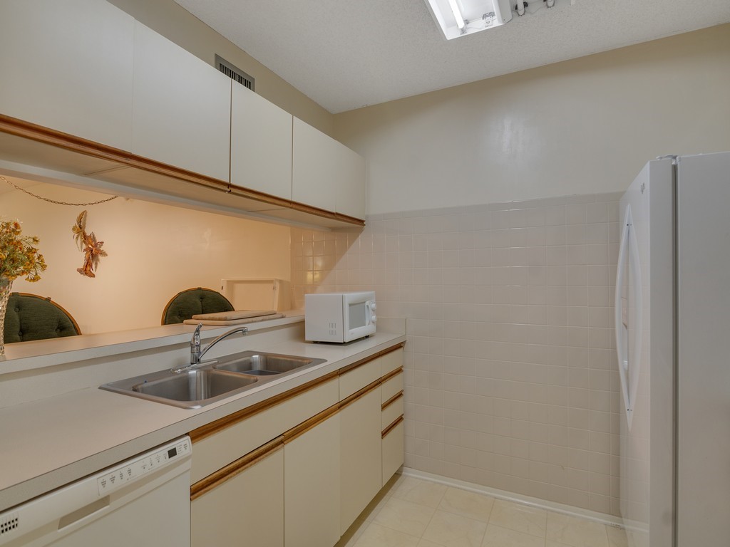 27 Plantation Drive, Unit 202 Vero Beach, FL 32966 - Photo 9 of 30 a close view of sink and tap