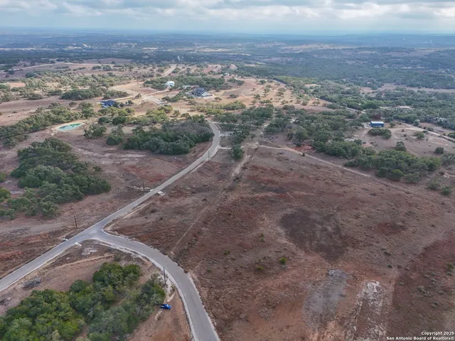 an aerial view of a house with a yard