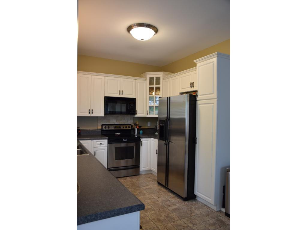 1817 Eric Graham, NC 27253 - Photo 11 of 24 a kitchen with stainless steel appliances granite countertop a refrigerator and a stove top oven