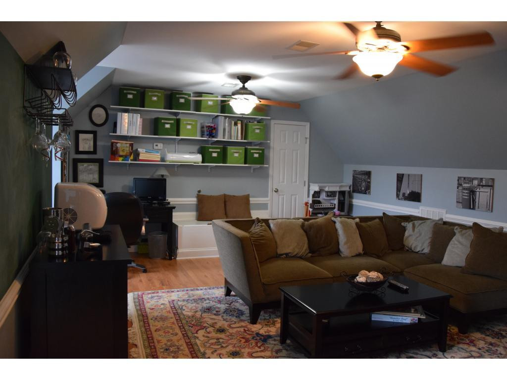 1817 Eric Graham, NC 27253 - Photo 13 of 24 a living room with furniture a chandelier and kitchen view