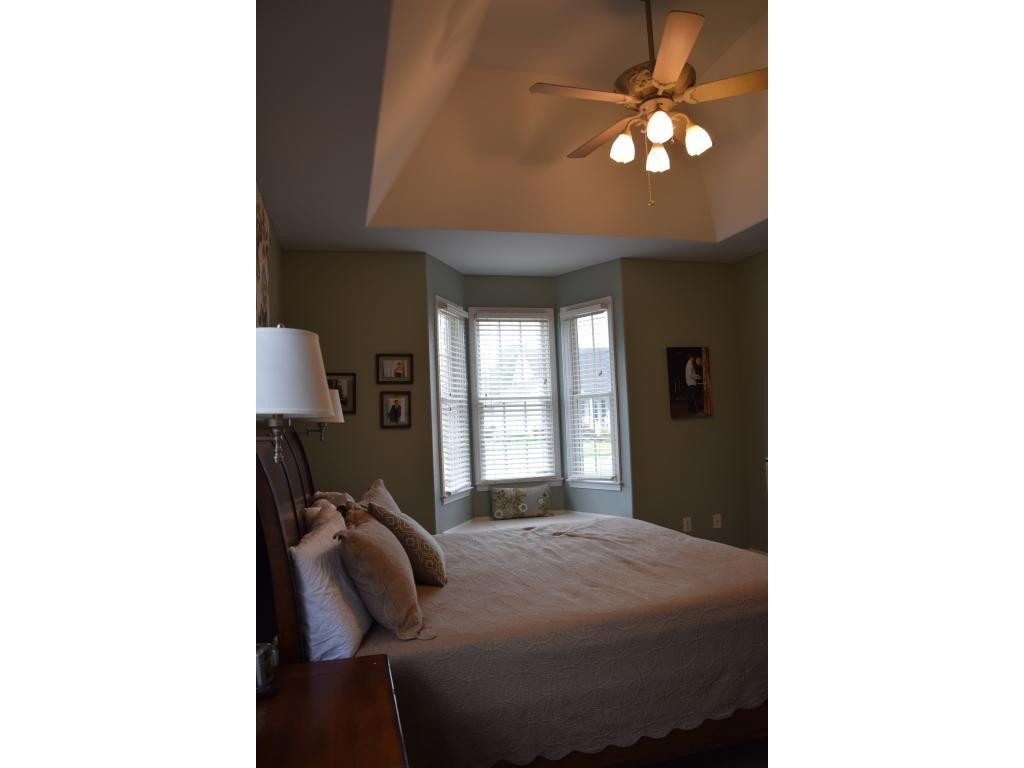 1817 Eric Graham, NC 27253 - Photo 15 of 24 a bedroom with a bed and a chandelier