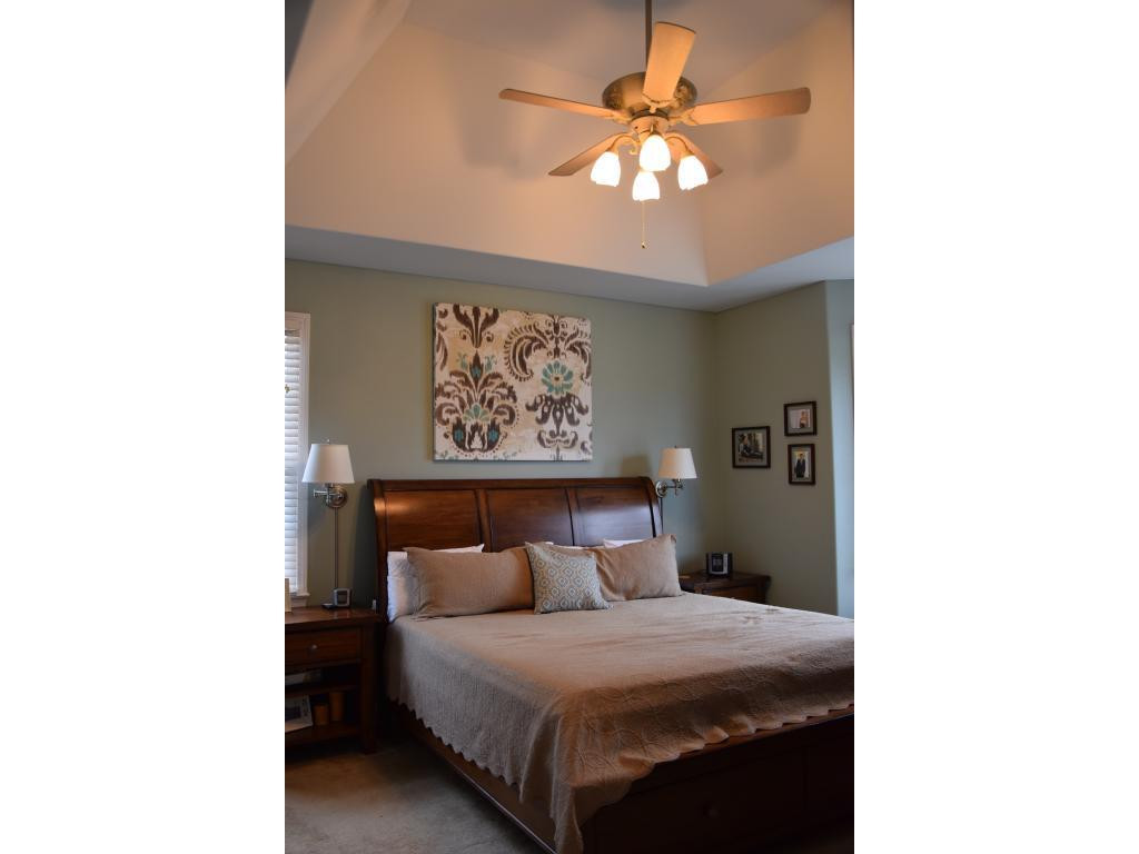 1817 Eric Graham, NC 27253 - Photo 16 of 24 a bedroom with a bed and a chandelier