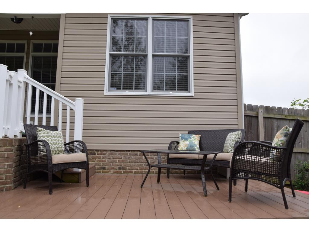 1817 Eric Graham, NC 27253 - Photo 22 of 24 a view of a deck with table and chairs with wooden floor and fence