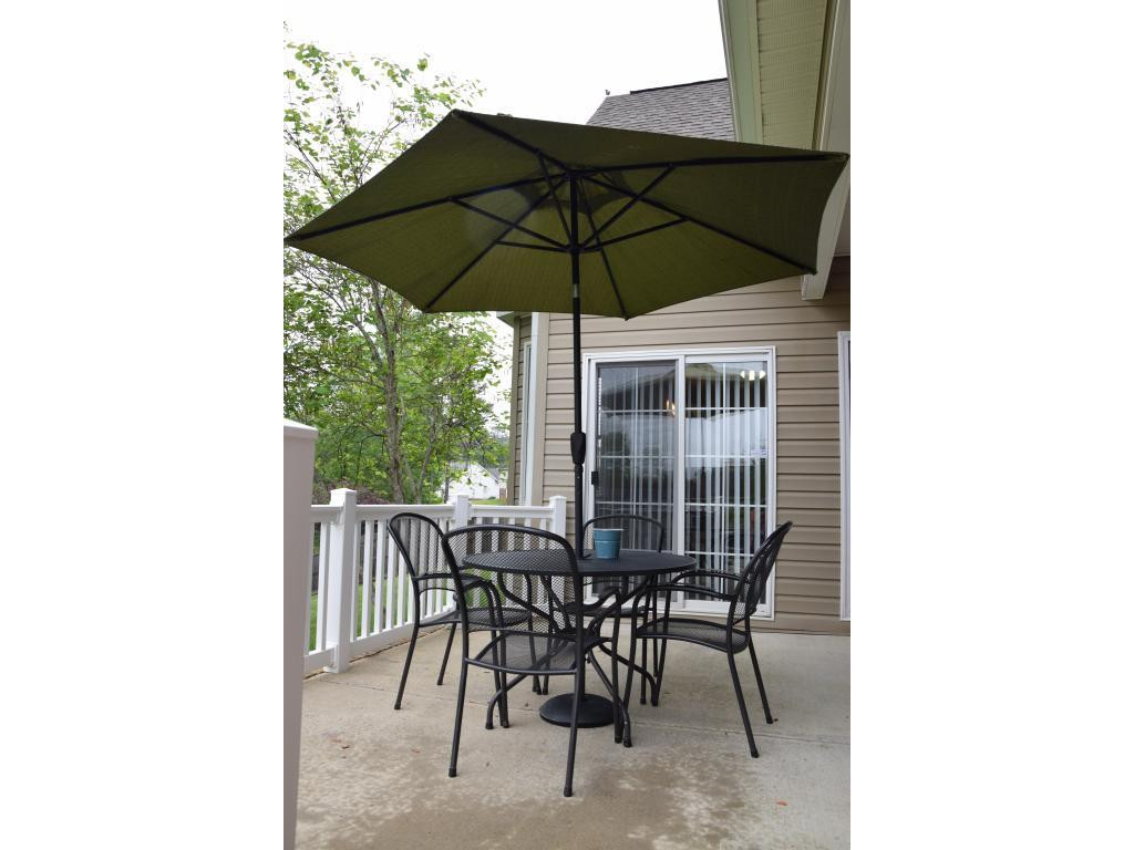 1817 Eric Graham, NC 27253 - Photo 23 of 24 a patio table and chairs under an umbrella