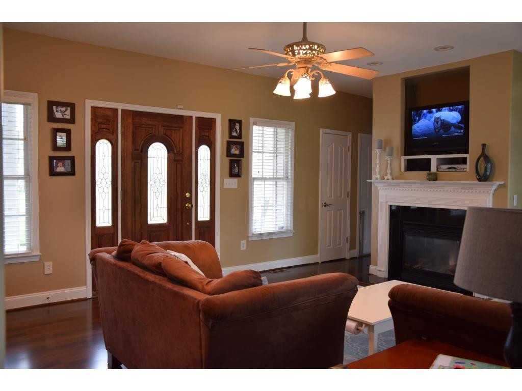 1817 Eric Graham, NC 27253 - Photo 6 of 24 a living room with furniture a fireplace and a flat screen tv
