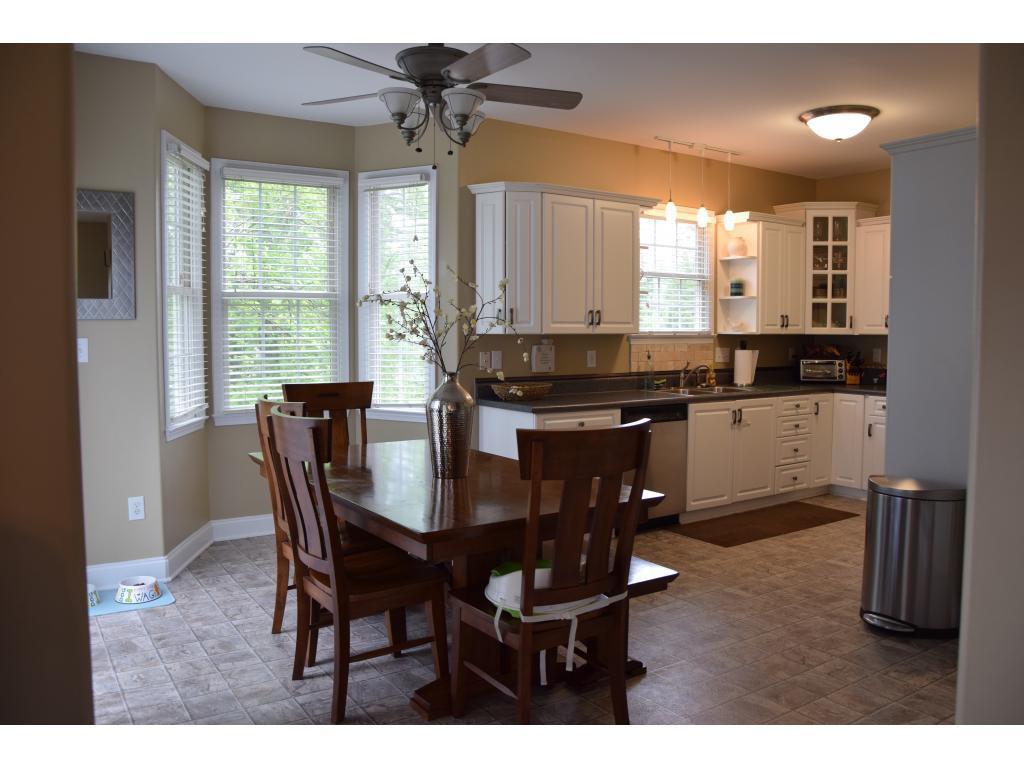 1817 Eric Graham, NC 27253 - Photo 9 of 24 a kitchen with a dining table chairs and granite counter tops