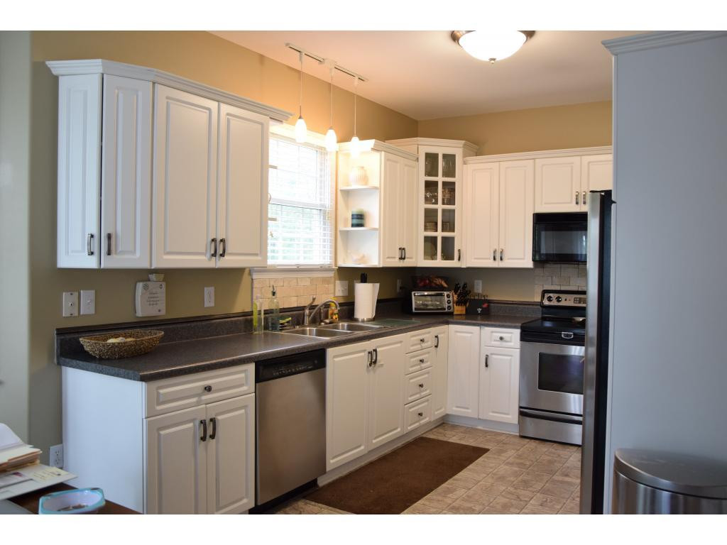 1817 Eric Graham, NC 27253 - Photo 10 of 24 a kitchen with stainless steel appliances granite countertop a stove a sink and a microwave