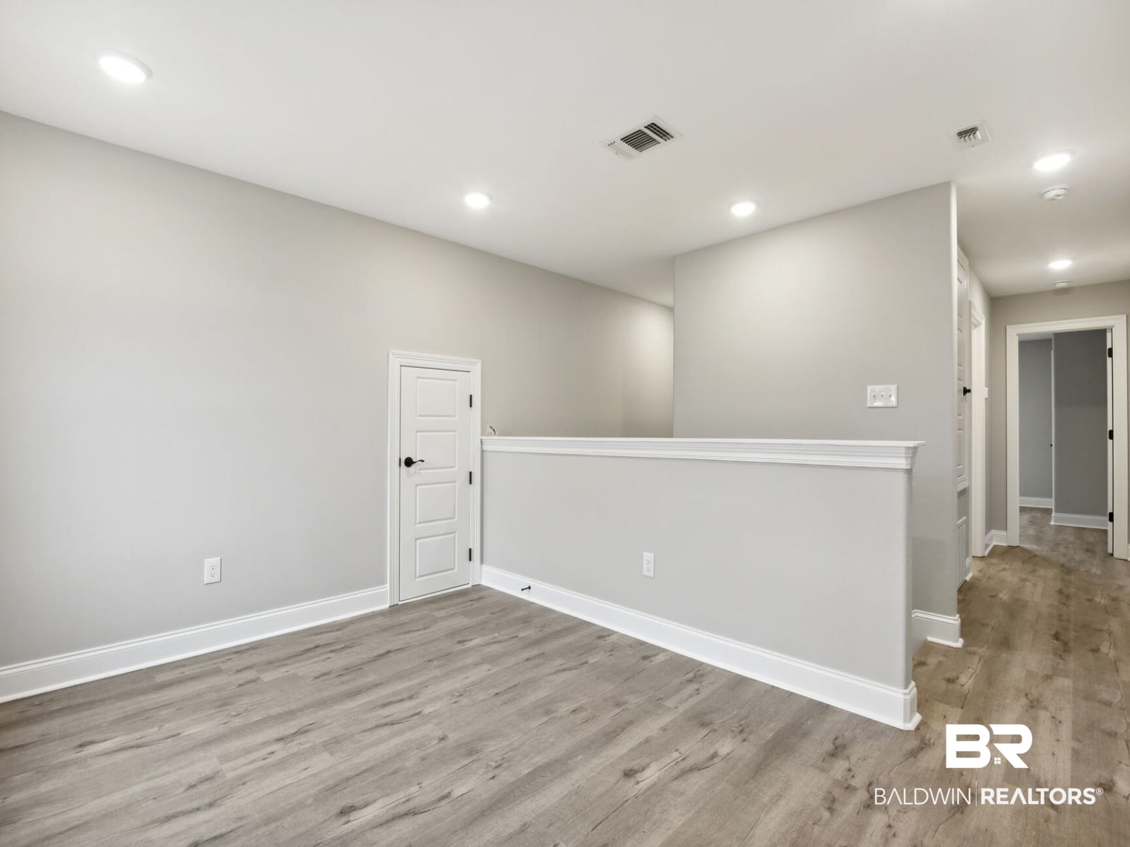 12922 Gondala Street Elberta, AL 36530 - Photo 14 of 20 Empty room with light wood-type flooring and recessed lighting