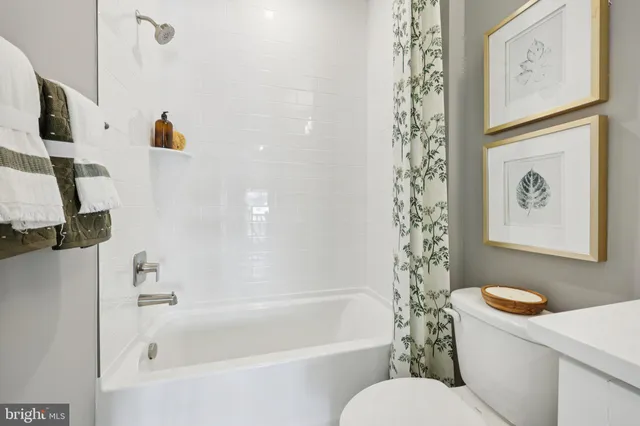 a white bath tub sitting next to a white toilet