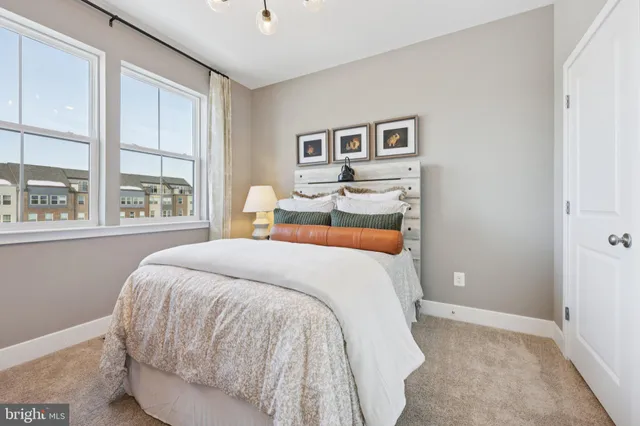 a bed sitting in a bedroom next to a window