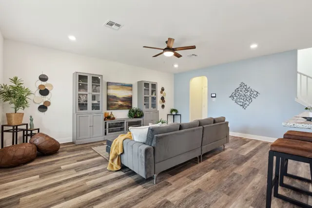 a living room with furniture and wooden floor