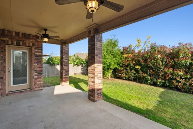 a view of a porch with furniture and garden