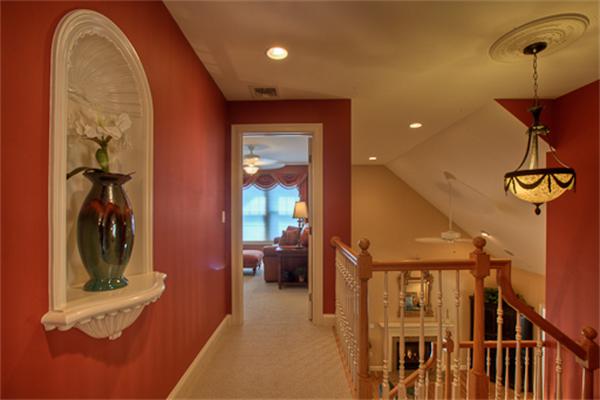 4 Coppersmyth Way, Unit 4 Lexington, MA 02421 - Photo 16 of 28 a view of hallway with furniture and a chandelier