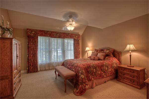 4 Coppersmyth Way, Unit 4 Lexington, MA 02421 - Photo 17 of 28 a bedroom with a bed and a chandelier
