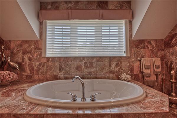 4 Coppersmyth Way, Unit 4 Lexington, MA 02421 - Photo 20 of 28 a bath tub sitting in a bathroom next to a window