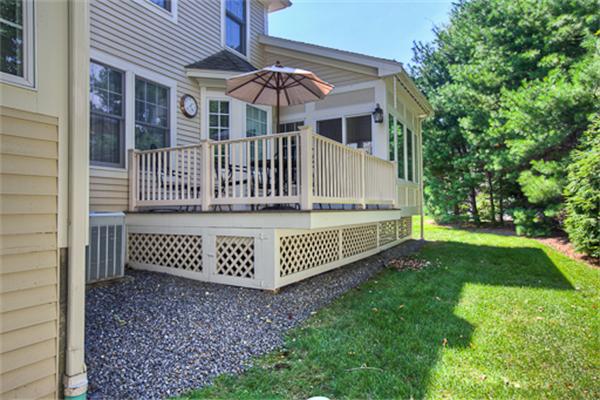 4 Coppersmyth Way, Unit 4 Lexington, MA 02421 - Photo 26 of 28 a view of house with a yard and deck